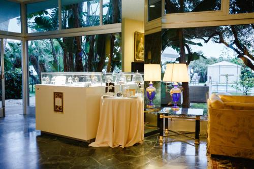 a lobby with a table and lamps and a couch at Grand Hotel Del Mare Resort & Spa in Bordighera