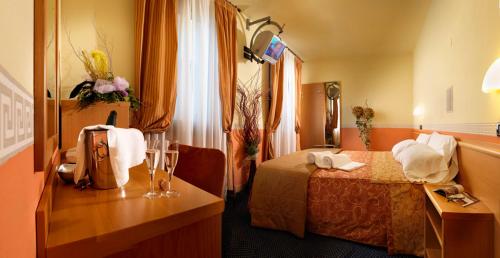 Postel nebo postele na pokoji v ubytování Hotel & Residence Roma