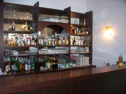 a bar with a lot of bottles of alcohol at Adonis Hotel Naxos in Apollon