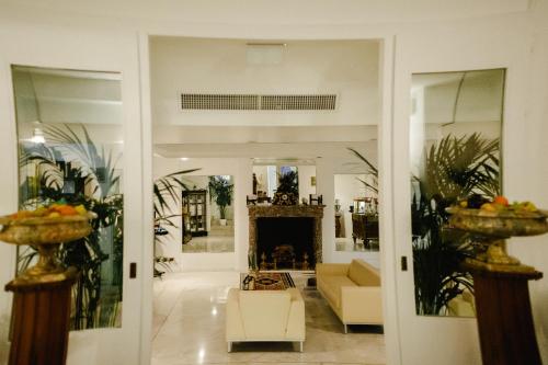 a living room with a couch and a fireplace at Grand Hotel Del Mare Resort & Spa in Bordighera