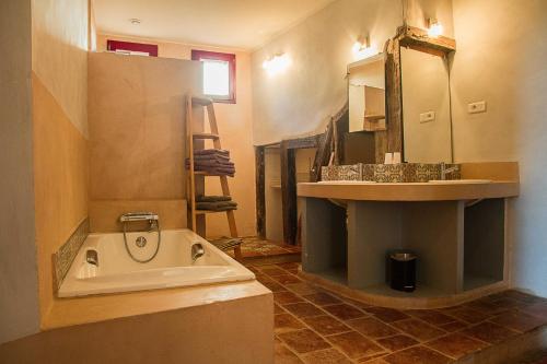 a bathroom with a sink and a bath tub at Croix de Pastel in Lavaur