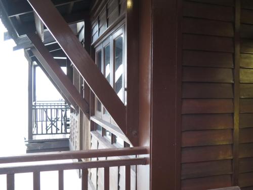 a wooden stairwell of a house with a balcony at Langkawi Lagoon Resort Water Chalet in Pantai Cenang