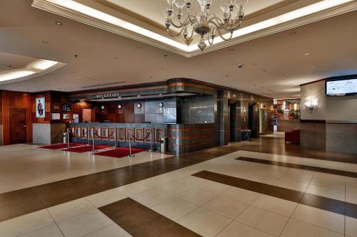 a large lobby with a chandelier in a building at Geneva Hotel in Amman