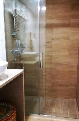 a shower with a glass door in a bathroom at Casinhas da Ajuda nº 29 in Lisbon