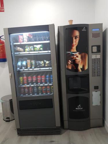 a soda vending machine with a picture of a woman at Casa Botes in Cuenca