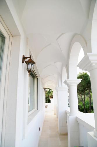 a hallway of a house with white walls and ceilings at Villa Angelina in Selva di Fasano