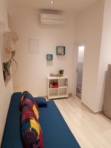 uma sala de estar com um tapete azul e uma parede branca em Nata em Korčula
