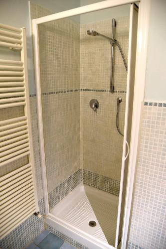a shower with a glass door in a bathroom at Podere Chiocciola in Poggibonsi