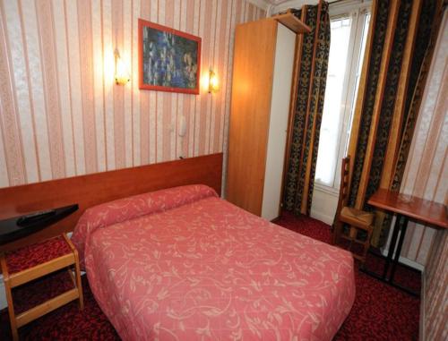 a bedroom with a red bed and a window at Sully Hôtel in Paris