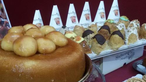 a table with a cake and a bunch of pastries at Il Duomo Salerno in Salerno