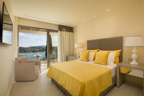 a bedroom with a large bed with yellow pillows at Rodostamo Hotel & Spa- Adults Friendly in Kommeno