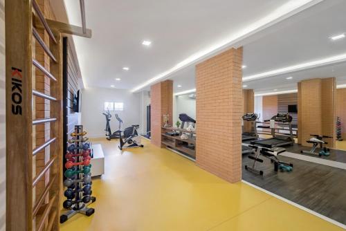 a gym with treadmills and exercise equipment in a building at Intercity Ribeirão Preto in Ribeirão Preto