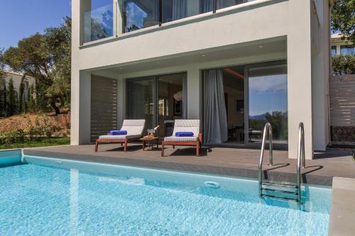 a house with a swimming pool next to a house at Rodostamo Hotel & Spa- Adults Friendly in Kommeno