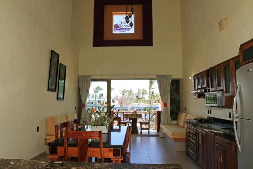 a kitchen with a table and a dining room at Villas Dulce Suenos in Rincon de Guayabitos