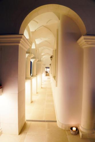 a hallway with an archway in a building at Villa Angelina in Selva di Fasano