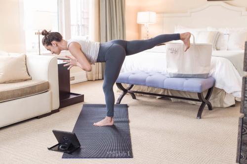 a woman doing a yoga pose on a mattress in a bedroom at Hotel DeLuxe in Portland