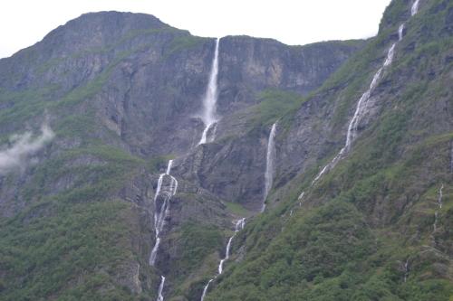a waterfall on the side of a mountain at Gudvangen Camping in Gudvangen