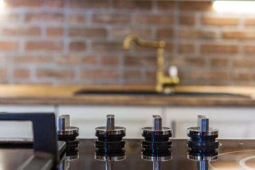 a group of four stove knobs on a stove top at Kuća za odmor Đeni in Drvenik Veli