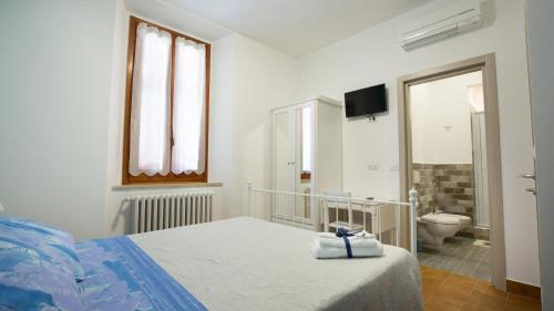 um quarto com uma cama e uma casa de banho com um WC em Marlin b&b em San Benedetto del Tronto