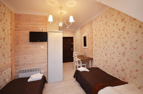 Łóżko lub łóżka w pokoju w obiekcie Okrągłe Resort SKI & SPA
