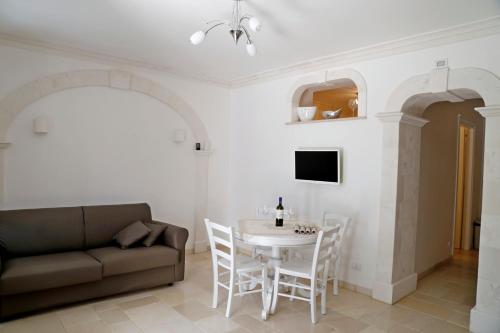 a living room with a couch and a table and chairs at Villa Angelina in Selva di Fasano