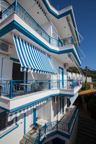 a view of a building with blue and white balconies at Kaskanis Apartments in Vráchos