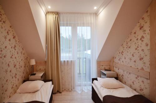 Voodi või voodid majutusasutuse Okrągłe Resort SKI & SAFARI toas