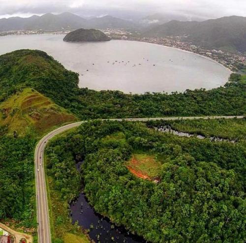 an aerial view of a road next to a lake at Chalés Ubatuba II in Ubatuba