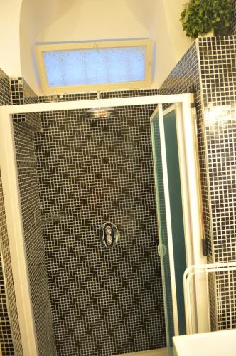 a bathroom with a shower with a glass door at Archivio dei Ricordi - Casa con vista a Ostuni in Ostuni