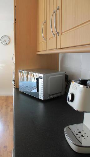 a microwave sitting on top of a kitchen counter at No.10 in Stornoway
