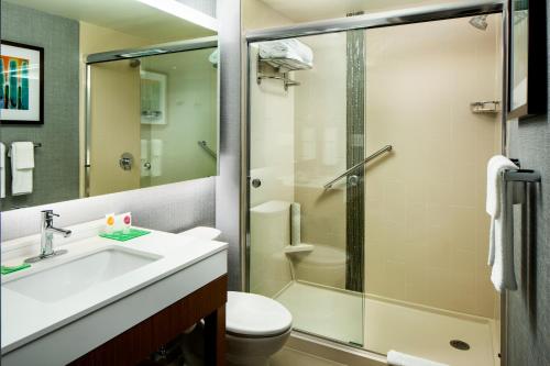 a bathroom with a shower and a sink and a toilet at Hyatt Place Sumter/Downtown in Sumter