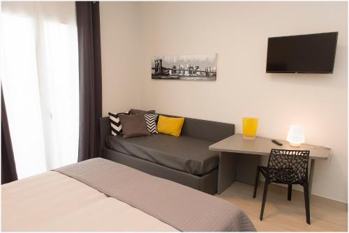 a room with a couch and a table and a tv at Dolce Vita in Zafferana Etnea