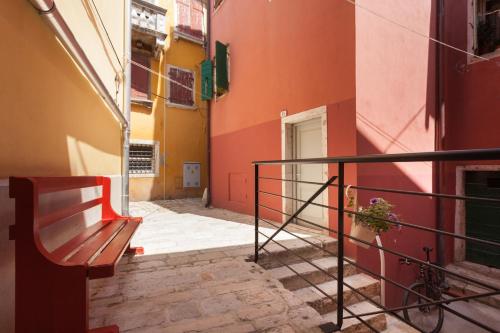 an alley with a bench next to a building at Apartments and Rooms Hey Rovinj in Rovinj