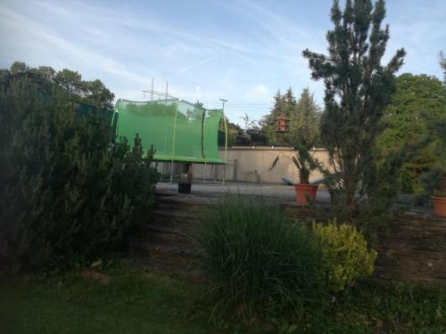 a green dump truck parked in a yard at Chalupa u Manišov in Laskár