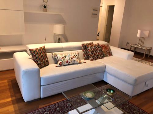 a white couch with pillows on it in a living room at Berga Exclusive Suite in Bari