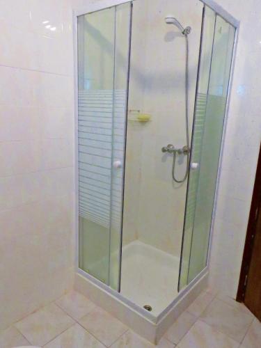 a shower with a glass door in a bathroom at Casa Eira do Povo in Vale de Colmeias