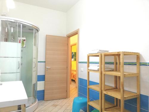 a room with a shower and a bunk bed at Capo d'Orlando Apartments in Capo dʼOrlando