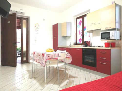 a kitchen with a table with a tablecloth on it at Capo d'Orlando Apartments in Capo dʼOrlando