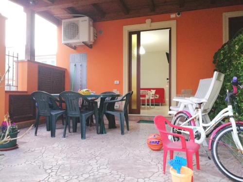 a patio with a table and chairs in a house at Capo d'Orlando Apartments in Capo dʼOrlando