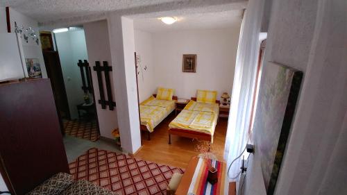 a room with two beds and a living room with a table at Villa Flora in Ohrid