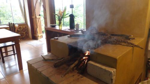 a fire in a stove in a living room at Pousada Alto do Tiê in Paraty