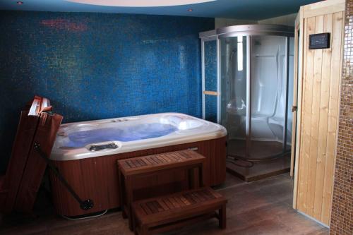 a bathroom with a large tub and a shower at Athorama Hotel in Ouranoupoli
