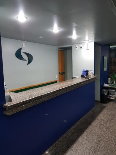 an office lobby with a blue and white counter top at Flat Saint Paul Residence in Bauru