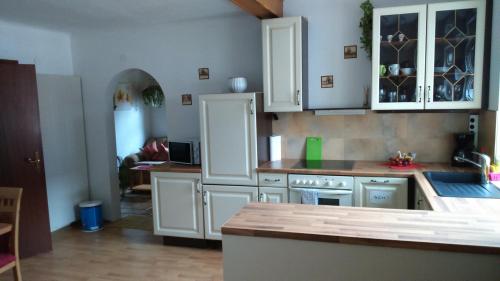 a kitchen with white cabinets and a counter top at Haus Ruf in Windischgarsten