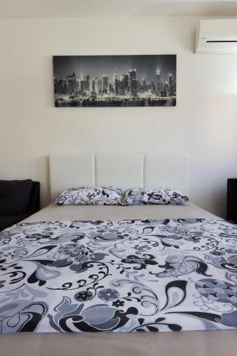 a bedroom with a bed with a painting on the wall at Zebra in Podgorica