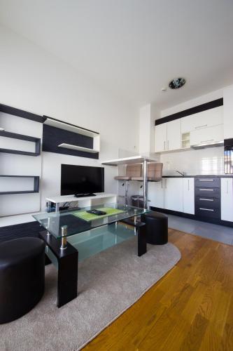 a living room with a glass table and black chairs at Zebra in Podgorica