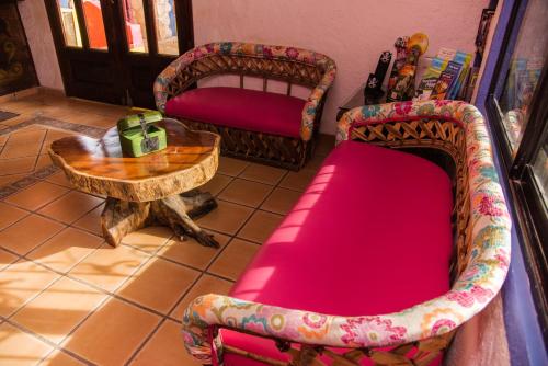 a living room with a couch and a table at Hacienda Maria Bonita Hotel in Playa del Carmen