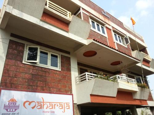 a building with a sign in front of it at Maharaja Home Stay Panhala in Panhāla