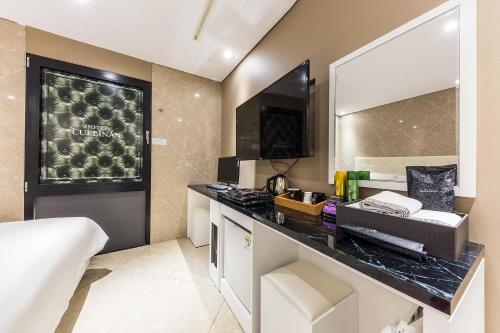 a bathroom with a counter with a sink and a mirror at Hotel Cullinan jongno in Seoul