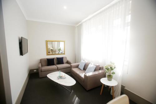 sala de estar con sofá y mesa en Hotel Bondi en Sídney